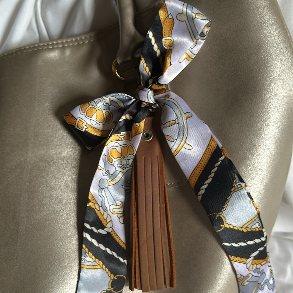 Brown TASSEL KEYCHAIN/bag charm with detachable scarf.